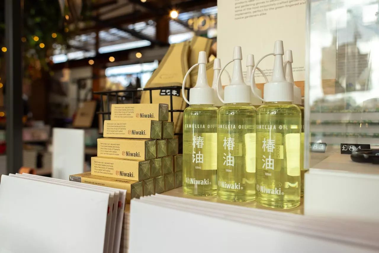 Stacked bottles of Camellia Oil on display in the TRP Shop