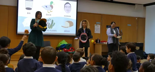 Schoolchildren playing an educational game in assembly