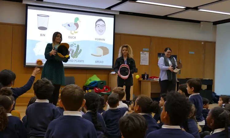 Schoolchildren playing an educational game in assembly