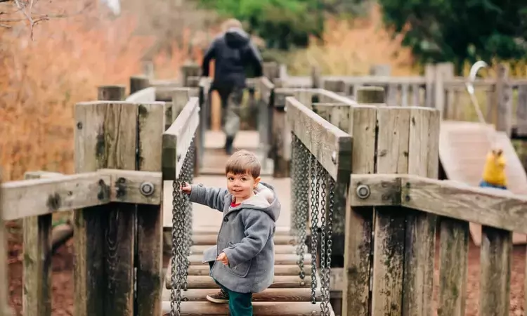 Boy playing on bridge at Diana Playground