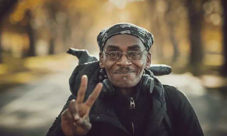 A man giving the peace sign in Hyde Park